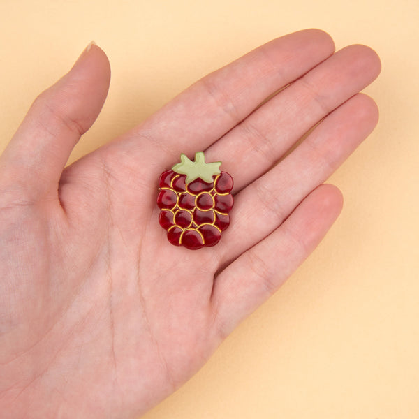 broche frambuesa original sostenido en una mano – Brocantia regalos singulares
