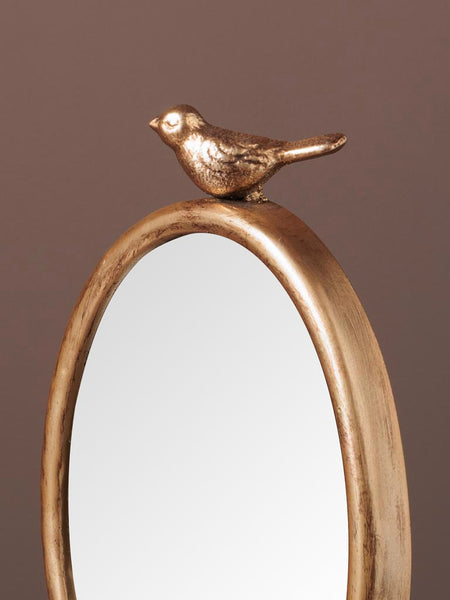 detalle pajarito dorado en espejo ovalado