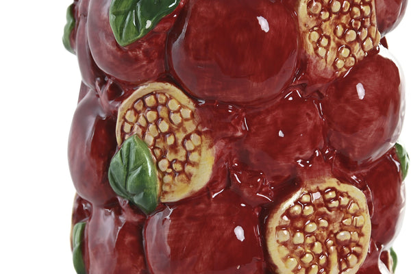 Detalle en primer plano de jarrón de cerámica con diseño de granadas rojas y hojas verdes