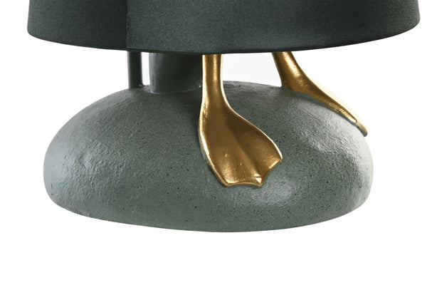 Detalle de las patas doradas y base texturizada de la lámpara de mesa con forma de pato