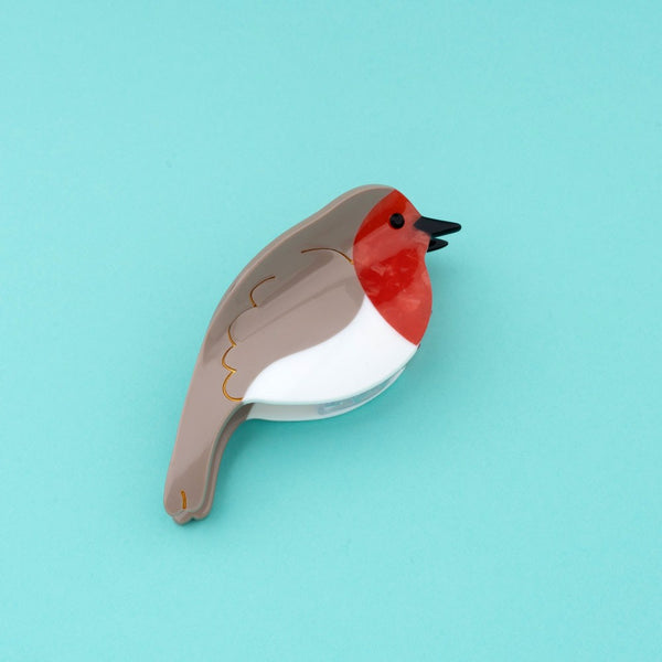 Pinza petirrojo sobre fondo celeste – Coucou Suzette