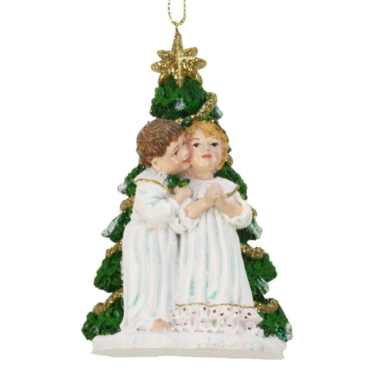 colgante navideño con niñas frente al árbol de Navidad