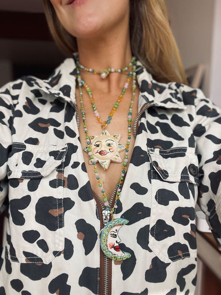 Collar sol y luna pintado a mano de cerámica siciliana combinado sobre camisa estampada