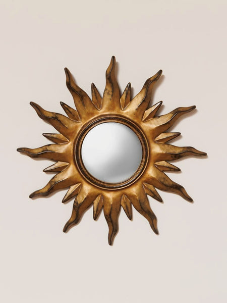 espejo sol convexo estilo vintage colgado en pared