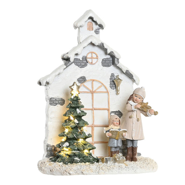 Escena navideña iluminada con niñas y árbol