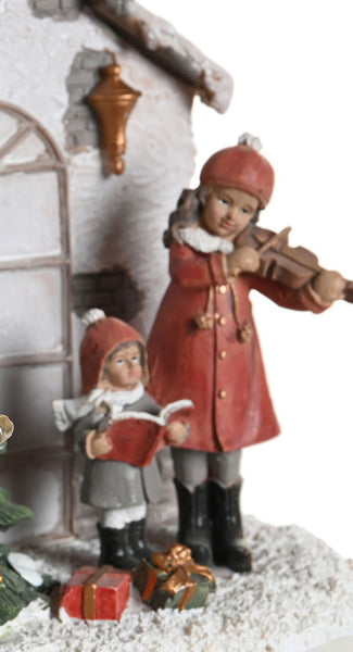 Detalle de niñas con violín y libro de villancicos