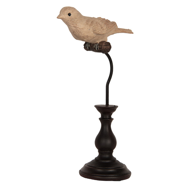 Detalle lateral de pájaro vintage sobre base de madera oscura