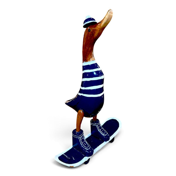 Figura de pato skater azul de madera reciclada vista lateral sobre monopatín