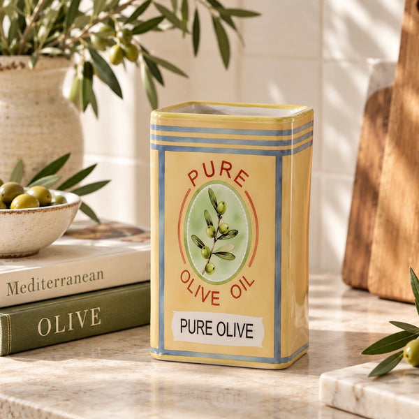 Jarrón Lata de Aceite Amarillo decorando una cocina mediterránea junto a ramas de olivo.