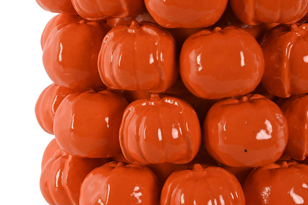 Detalle textura jarrón de cerámica con forma de mandarinas esmaltadas naranja brillante