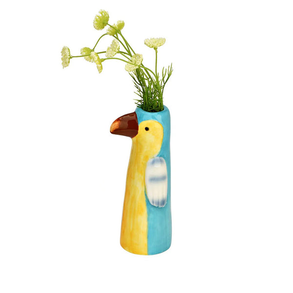 Jarrón decorativo de porcelana con diseño de tucán y flores.