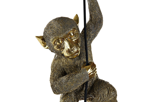 Lámpara decorativa mono dorado encendida de noche