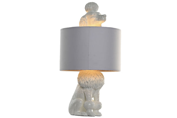 Lámpara encendida con interior dorado y figura de perro