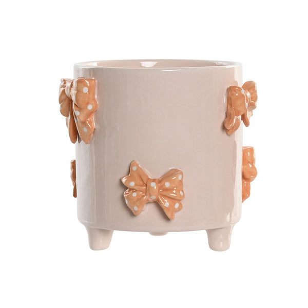 Macetero de cerámica rosa con lazos decorativos en relieve