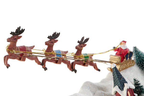 detalle del trineo de Papá Noel con renos sobre el pueblo